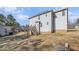 Exterior view of the house featuring a grassy backyard and a wooden deck at 329 Silver Creek Dr, Clayton, NC 27520