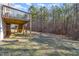 View of the backyard featuring trees and the back deck at 329 Silver Creek Dr, Clayton, NC 27520