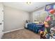 Bedroom with an arcade machine to the side of a bed next to a window at 329 Silver Creek Dr, Clayton, NC 27520