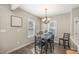 Cozy dining area featuring a chandelier and natural light from two windows at 329 Silver Creek Dr, Clayton, NC 27520