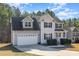Charming two-story home with a two-car garage, black shutters, and manicured landscaping at 329 Silver Creek Dr, Clayton, NC 27520