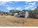 View of home's exterior with two-car garage, black shutters and landscaping at 329 Silver Creek Dr, Clayton, NC 27520