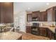 Well-equipped kitchen with dark cabinetry, granite countertops, and modern appliances at 329 Silver Creek Dr, Clayton, NC 27520