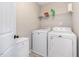 Functional laundry room with a washer, dryer, and storage at 329 Silver Creek Dr, Clayton, NC 27520