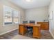 Bright home office featuring a wood desk, neutral walls, and a window overlooking the front yard at 329 Silver Creek Dr, Clayton, NC 27520