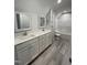 Modern bathroom featuring double sink vanity, white cabinets, quartz countertops, and a tub shower combo at 333 S Main St, Four Oaks, NC 27524