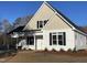 Charming white exterior elevation with black shutters and a covered side porch at 333 S Main St, Four Oaks, NC 27524