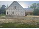 New construction shows the exterior elevation with protective house wrap, and features a large carport at 333 S Main St, Four Oaks, NC 27524