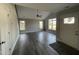 Open-concept living room with modern lighting, wood flooring, and large windows providing natural light at 333 S Main St, Four Oaks, NC 27524