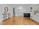 A large living room with hardwood floors, light walls, console table, and stairs to the left at 3416 Oates Dr, Raleigh, NC 27604