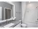 This bathroom has gray walls with white subway tiled shower, granite countertop, and a bright recessed light at 344 Arcadius Dr, Clayton, NC 27520