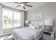 This primary bedroom features a neutral color palette, ceiling fan and large windows for abundant natural light at 344 Arcadius Dr, Clayton, NC 27520