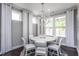 Bright dining room with a modern chandelier, white table and chairs, and lots of natural light at 344 Arcadius Dr, Clayton, NC 27520
