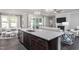 Open concept kitchen with quartz countertops, stainless appliances, and dark wood flooring at 344 Arcadius Dr, Clayton, NC 27520