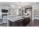 Spacious open-concept kitchen featuring dark cabinets, stainless appliances and a large island at 344 Arcadius Dr, Clayton, NC 27520