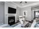 Cozy living room featuring a fireplace, TV, plush seating, and hardwood floors at 344 Arcadius Dr, Clayton, NC 27520