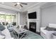 Open-concept living room featuring a fireplace, TV, plush seating, and sliding doors to a patio at 344 Arcadius Dr, Clayton, NC 27520