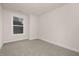 An empty, freshly-painted bedroom with carpet floors and one window at 344 Church St, Morrisville, NC 27560