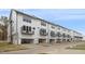 Modern townhouse exterior with white siding, black trim, individual balconies, and garage parking at 344 Church St, Morrisville, NC 27560
