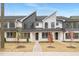Modern townhome with painted brick, black metal roof, and manicured front lawn at 344 Church St, Morrisville, NC 27560