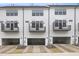 New townhouse exteriors with white siding, black trim, individual balconies, and garage parking at 344 Church St, Morrisville, NC 27560