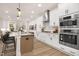Modern kitchen boasting stainless steel appliances, white cabinetry, and spacious island at 344 Church St, Morrisville, NC 27560
