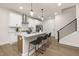 Stylish kitchen with a large granite island, stainless steel appliances, and modern barstools at 344 Church St, Morrisville, NC 27560