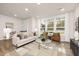 Bright living room featuring modern furnishings, large windows, and stylish decor at 344 Church St, Morrisville, NC 27560