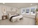 Bright main bedroom showcasing soft carpet, a plush bed, ample lighting, and stylish furnishings at 344 Church St, Morrisville, NC 27560