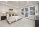 Serene main bedroom with a large bed, neutral tones, recessed lighting, and access to an outdoor balcony at 344 Church St, Morrisville, NC 27560