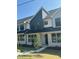 Modern townhome featuring a brick facade and a mix of dark and light siding and black window frames at 344 Church St, Morrisville, NC 27560