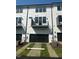 Townhome exterior with private garages and balconies and a manicured lawn at 344 Church St, Morrisville, NC 27560
