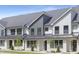 Beautiful townhouse with white brick and gray siding, complemented by well-maintained landscaping at 344 Church St, Morrisville, NC 27560