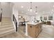 Open kitchen with island flowing into the living area and stairs at 344 Church St, Morrisville, NC 27560