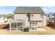 The backyard features a screened-in porch, patio, and a well-kept lawn enclosed by a wooden fence at 372 Lynshire Ave, Clayton, NC 27527