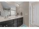 Well-lit primary bathroom featuring a double vanity with dark cabinets and plenty of storage space at 372 Lynshire Ave, Clayton, NC 27527