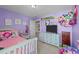 Purple bedroom with a cozy bed, plush carpet, and plenty of space for fun and relaxation at 372 Lynshire Ave, Clayton, NC 27527