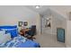 Comfortable attic bedroom featuring a cozy workspace, bed with patterned bedding, and lots of natural light at 372 Lynshire Ave, Clayton, NC 27527