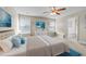 Spacious main bedroom featuring a ceiling fan, a large window, and a private ensuite bathroom at 372 Lynshire Ave, Clayton, NC 27527