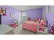 Vibrant bedroom with a cute theme, featuring a pink bed, play kitchen, and lots of toys at 372 Lynshire Ave, Clayton, NC 27527
