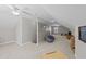 A spacious and versatile bonus room area with plush carpeting and a bright ceiling fan at 372 Lynshire Ave, Clayton, NC 27527