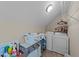 Functional laundry room with a washer, dryer, and overhead shelving for storage and organization at 372 Lynshire Ave, Clayton, NC 27527
