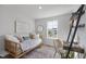 Cozy bedroom with daybed, desk, a patterned rug, and natural light from the window at 509 Sherron Rd # 22, Durham, NC 27703