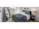 Cozy bedroom with patterned bedding, full-length mirror, bedside table and lamp, and natural light at 509 Sherron Rd # 22, Durham, NC 27703
