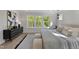This bedroom features a large window, a modern dresser, a plush rug, and a neutral color palette at 509 Sherron Rd # 22, Durham, NC 27703