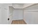 Walk-in closet with wood floors and basic wooden shelving and a white door at 509 Sherron Rd # 22, Durham, NC 27703