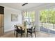 Dining room with modern light fixture, natural wood table, and sliding glass door at 509 Sherron Rd # 22, Durham, NC 27703
