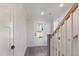 Bright entryway featuring wood flooring, a staircase with a wood railing, and a view of the front door at 509 Sherron Rd # 22, Durham, NC 27703