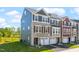 Beautiful exterior view of new townhomes with stone accents, siding, and well-maintained landscaping at 509 Sherron Rd # 22, Durham, NC 27703