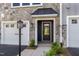 Inviting front entrance featuring a stone facade and a stylish black door with transom window at 509 Sherron Rd # 22, Durham, NC 27703